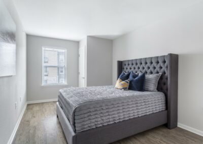 Bedroom with faux wood flooring and a queen size bed